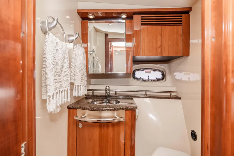 Do Less Yacht Photos Pics Luxurious 2007 Sea Ray 48 Sundancer yacht bathroom with wood cabinetry and elegant fixtures.