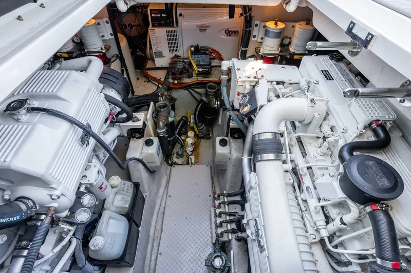 Do Less Yacht Photos Pics Engine room of 2007 Sea Ray 48 Sundancer yacht, showcasing dual engines and mechanical components.