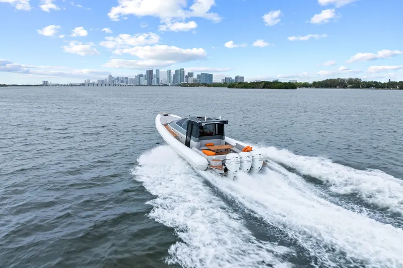 Yacht Photos Pics Magazzu TARGA 45 boat cruising on water with city skyline in background, 2021 model.