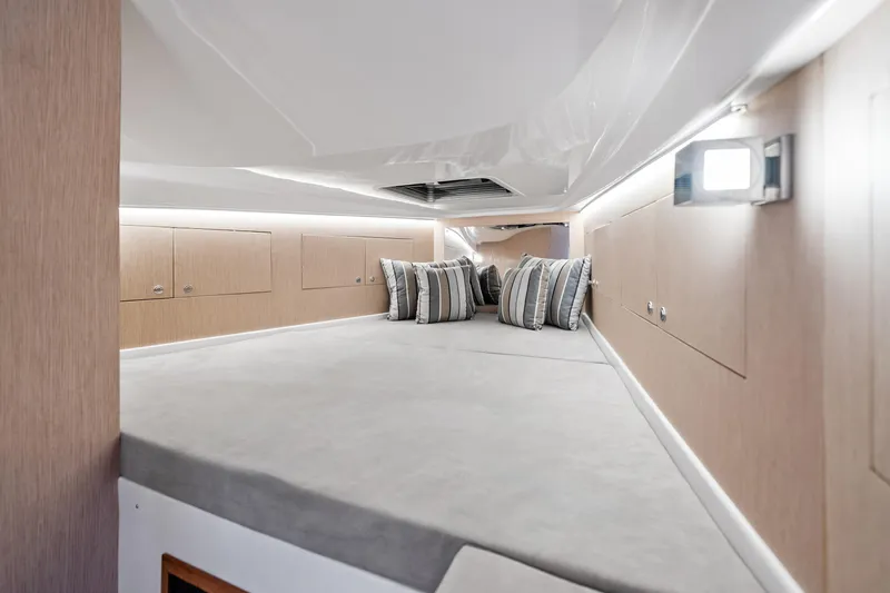  Yacht Photos Pics Luxurious interior cabin of 2021 Magazzu TARGA 45 with modern design and striped pillows.