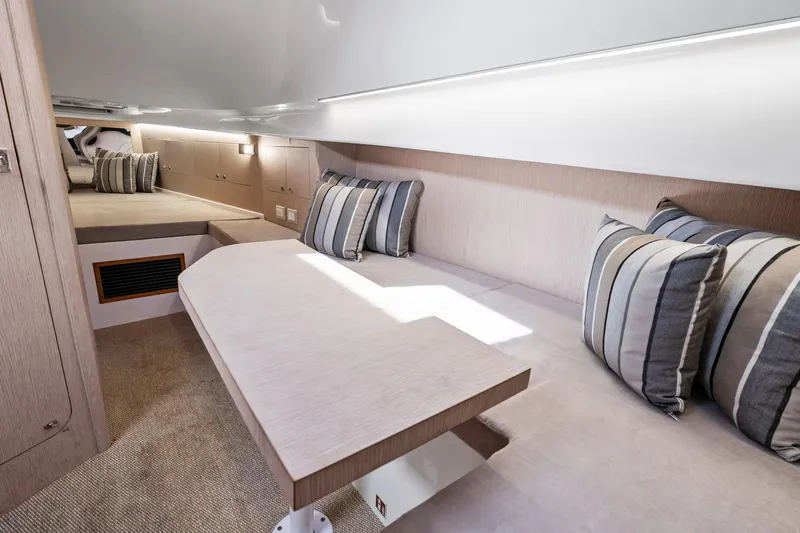  Yacht Photos Pics Interior of 2021 Magazzu TARGA 45 yacht with cozy seating and striped cushions.