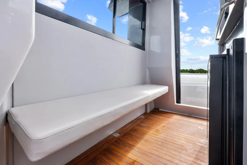  Yacht Photos Pics Interior view of 2021 Magazzu TARGA 45 yacht with wooden flooring and cushioned seating.