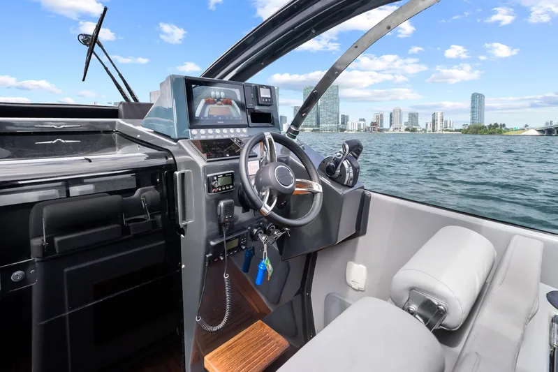  Yacht Photos Pics Interior view of 2021 Magazzu TARGA 45 yacht cockpit with city skyline in background.
