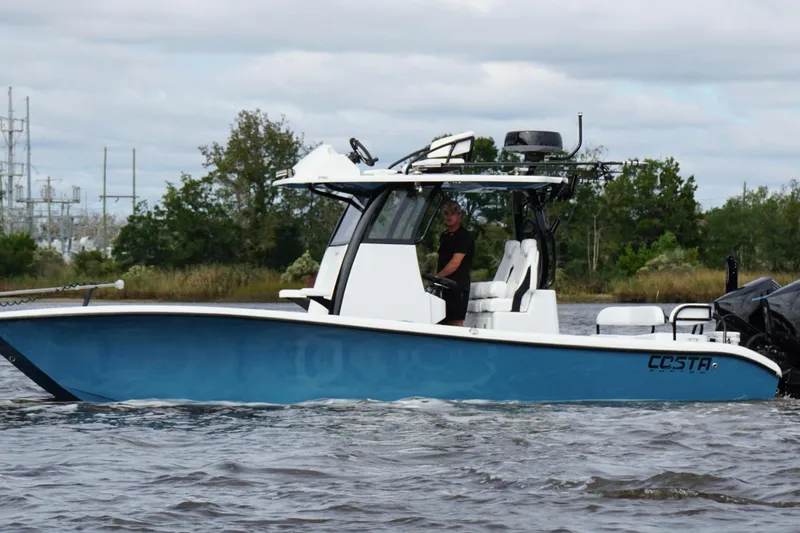  Yacht Photos Pics 2025 Costa Custom Boats 264 HC cruising on a river with lush greenery in the background.