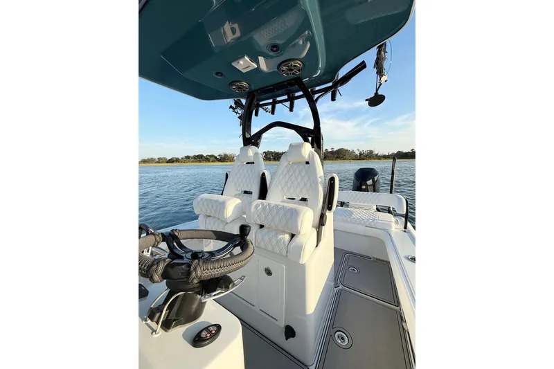  Yacht Photos Pics 2025 Costa Custom Boats 264 HC interior with white seating and steering wheel on water.