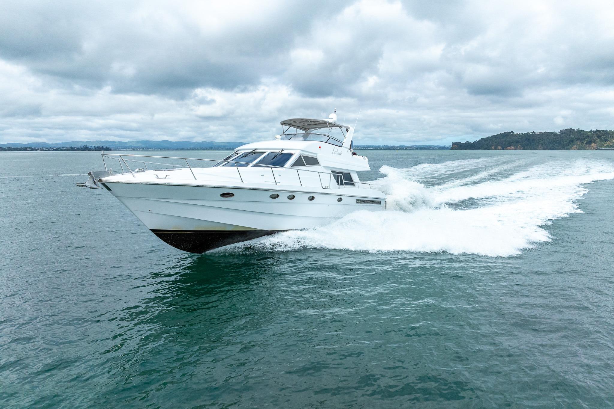 1995 Comar Clanship 52 yacht cruising on open water under cloudy skies.