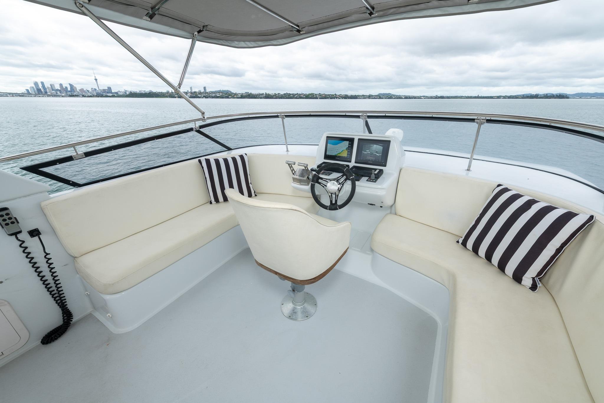 Flybridge of 1995 Comar Clanship 52 yacht with seating and navigation equipment.