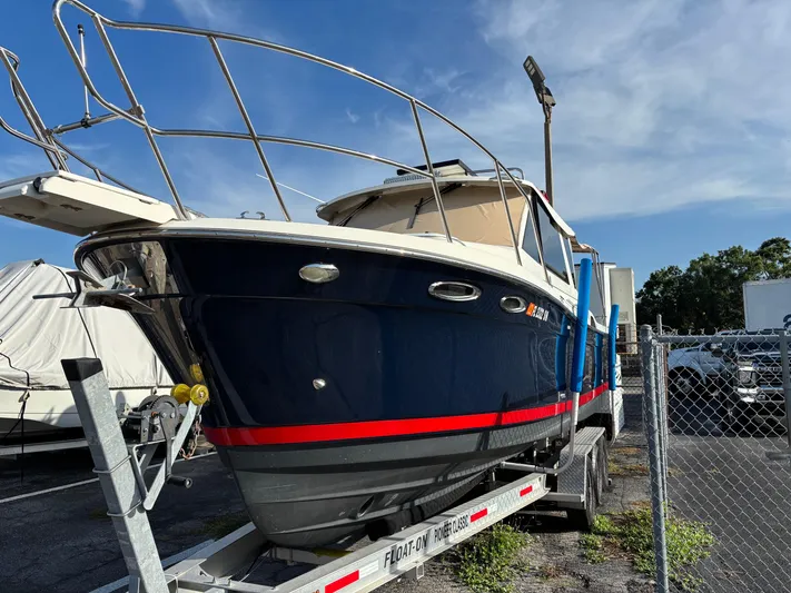 Y Knot Yacht Photos Pics 2017 Cutwater C-28 Deluxe boat on trailer, parked outdoors under clear sky.
