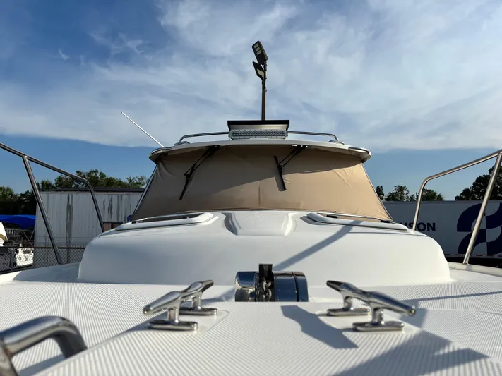 Y Knot Yacht Photos Pics 2017 Cutwater C-28 Deluxe boat, front view with clear sky background.