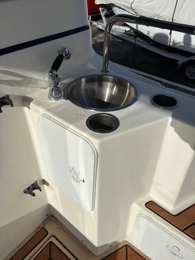 Y Knot Yacht Photos Pics 2017 Cutwater C-28 Deluxe boat sink and faucet with storage compartments.