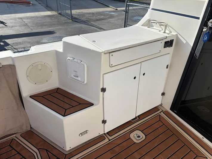 Y Knot Yacht Photos Pics 2017 Cutwater C-28 Deluxe boat interior with storage cabinets and teak flooring.