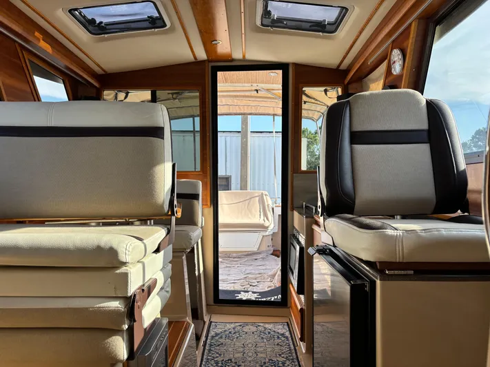 Y Knot Yacht Photos Pics Interior of 2017 Cutwater C-28 Deluxe boat with seating and sunroof.