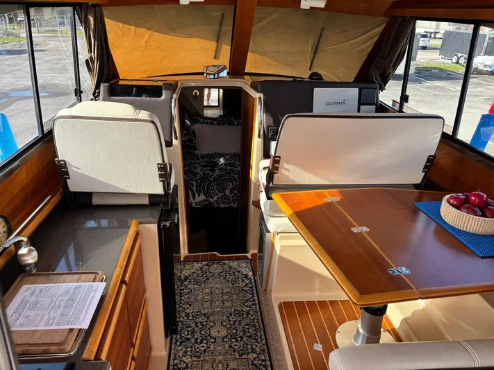 Y Knot Yacht Photos Pics Interior of 2017 Cutwater C-28 Deluxe boat with dining area and navigation equipment.