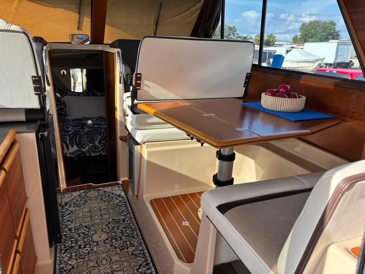 Y Knot Yacht Photos Pics Interior of 2017 Cutwater C-28 Deluxe boat with dining area and cozy cabin.