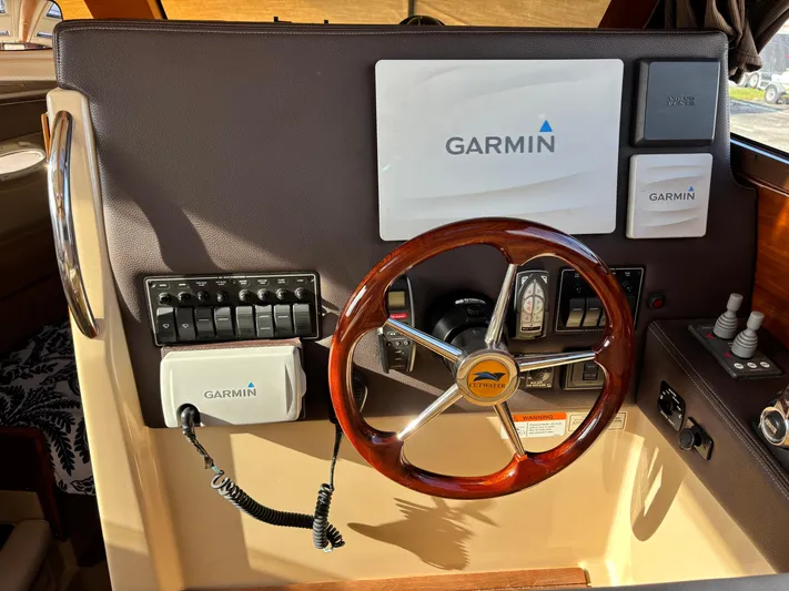 Y Knot Yacht Photos Pics 2017 Cutwater C-28 Deluxe helm with Garmin navigation and wooden steering wheel.