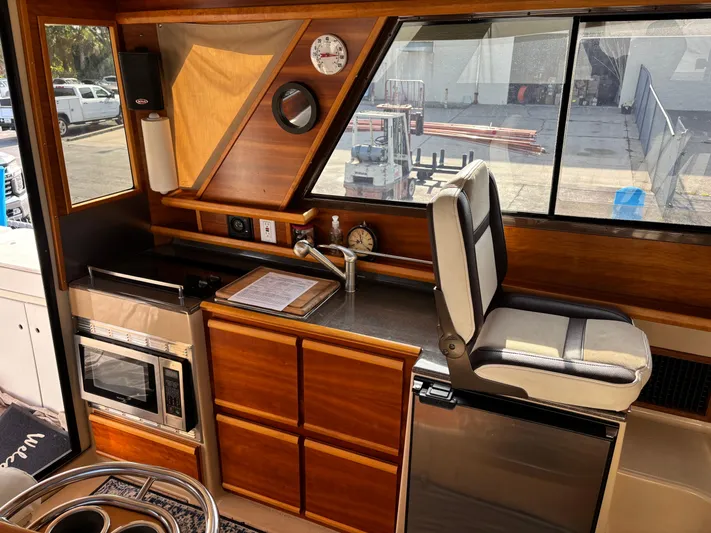 Y Knot Yacht Photos Pics Interior of 2017 Cutwater C-28 Deluxe boat with kitchen and seating area.