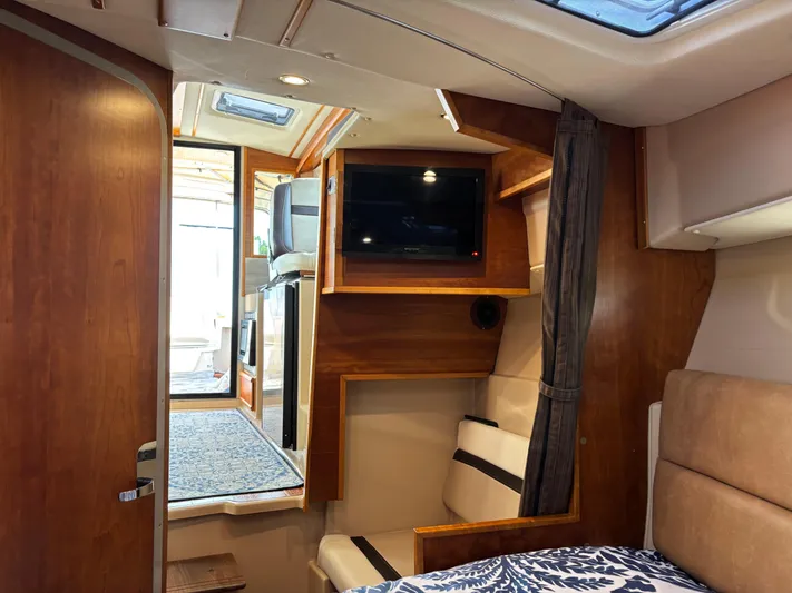 Y Knot Yacht Photos Pics Interior of 2017 Cutwater C-28 Deluxe boat with wood finish and TV.