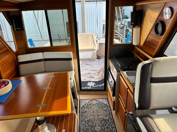 Y Knot Yacht Photos Pics Interior of 2017 Cutwater C-28 Deluxe boat with dining area and kitchenette.