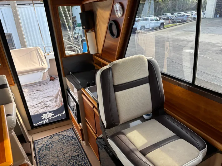 Y Knot Yacht Photos Pics Interior of 2017 Cutwater C-28 Deluxe boat with seating and kitchenette area.