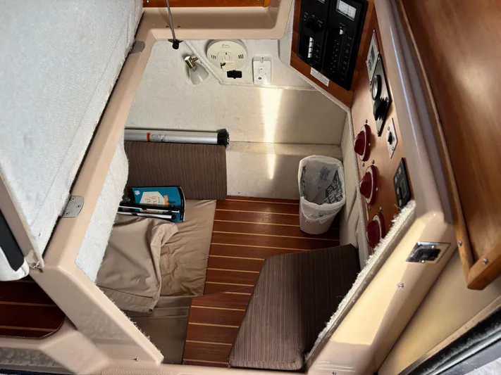 Y Knot Yacht Photos Pics 2017 Cutwater C-28 Deluxe cabin interior with control panel and seating area.
