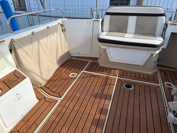 Y Knot Yacht Photos Pics 2017 Cutwater C-28 Deluxe boat interior with wood flooring and cushioned seating.