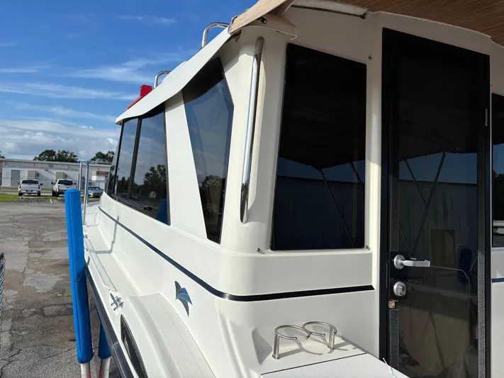 Y Knot Yacht Photos Pics 2017 Cutwater C-28 Deluxe boat, side view, docked under clear blue sky.