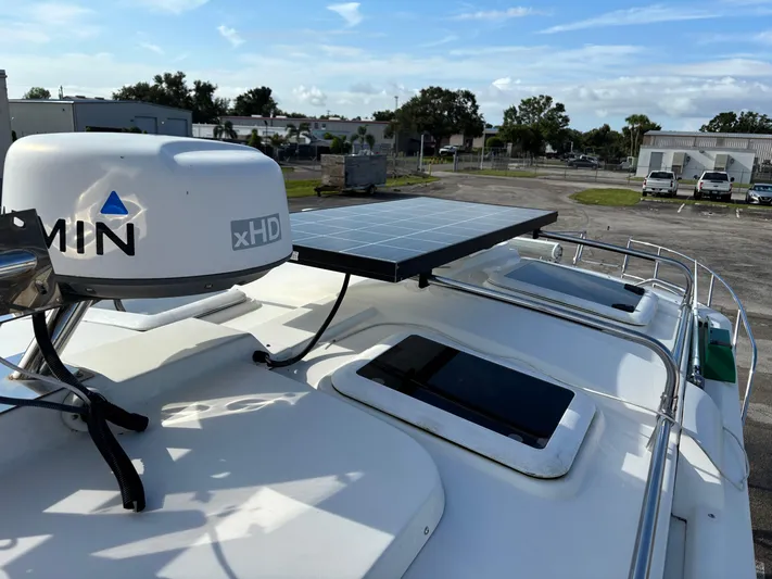 Y Knot Yacht Photos Pics 2017 Cutwater C-28 Deluxe boat with radar and solar panel on deck.