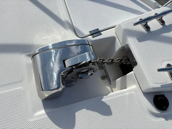 Y Knot Yacht Photos Pics Anchor windlass on 2017 Cutwater C-28 Deluxe boat deck, featuring stainless steel finish.