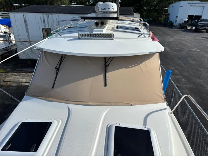 Y Knot Yacht Photos Pics 2017 Cutwater C-28 Deluxe boat with Garmin equipment, docked in a marina.