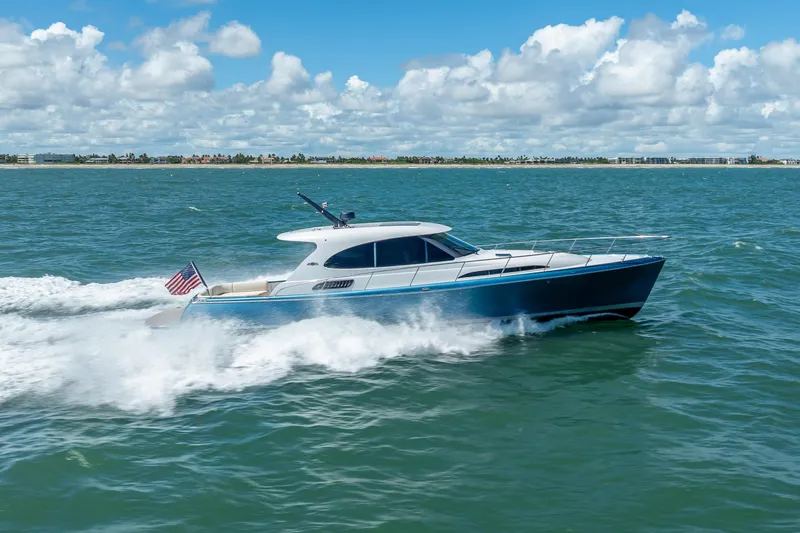 Priceless Yacht Photos Pics 2019 Palm Beach Motor Yachts GT50 cruising on open water under a clear sky.