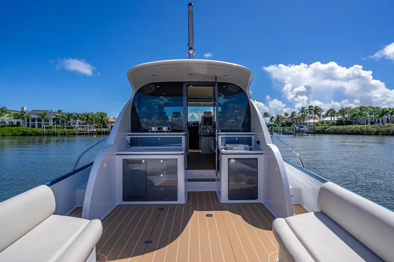 Priceless Yacht Photos Pics 2019 Palm Beach Motor Yachts GT50 on serene water, showcasing elegant deck and seating.