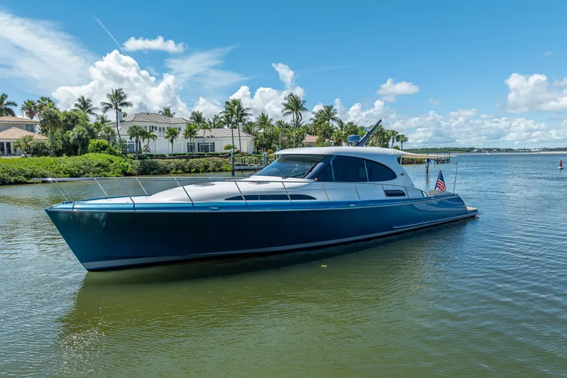 Priceless Yacht Photos Pics 2019 Palm Beach Motor Yachts GT50 cruising on a sunny day near waterfront homes.