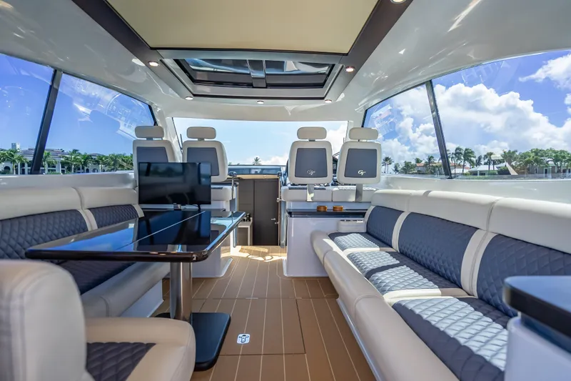 Priceless Yacht Photos Pics Luxurious interior of 2019 Palm Beach Motor Yachts GT50 with elegant seating and panoramic windows.