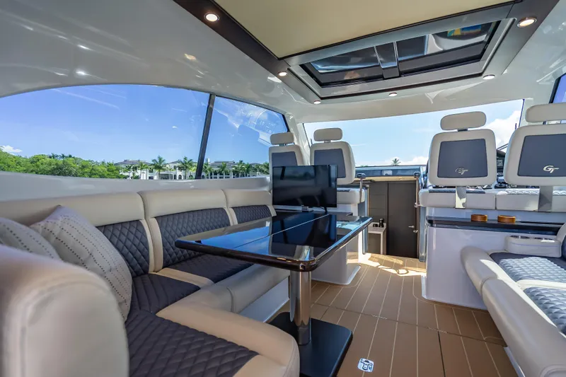 Priceless Yacht Photos Pics Luxurious interior of 2019 Palm Beach Motor Yachts GT50 with elegant seating and panoramic windows.