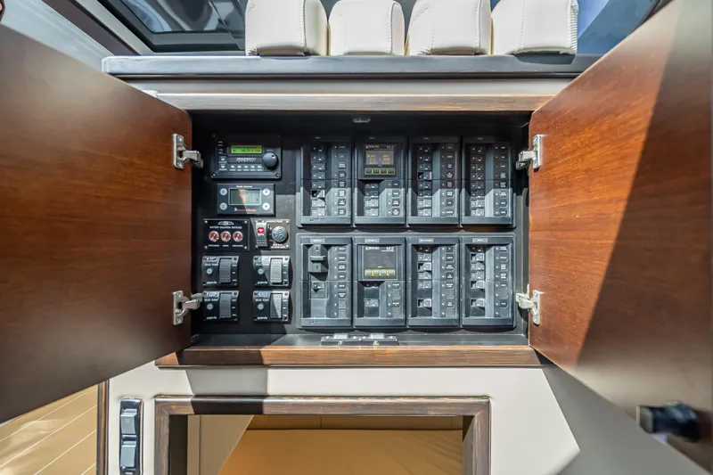 Priceless Yacht Photos Pics Electrical panel inside 2019 Palm Beach Motor Yachts GT50, featuring switches and controls.