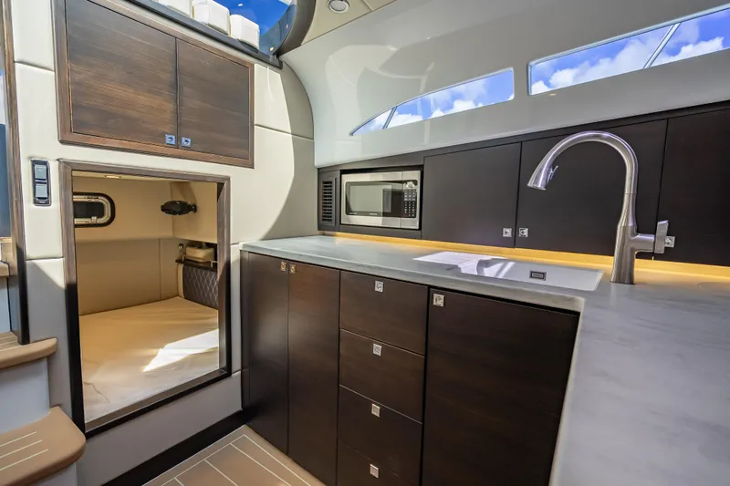 Priceless Yacht Photos Pics Luxurious 2019 Palm Beach Motor Yachts GT50 interior with modern kitchen and sleek cabinetry.