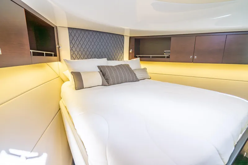 Priceless Yacht Photos Pics Luxurious 2019 Palm Beach Motor Yachts GT50 cabin interior with elegant bedding and wood accents.