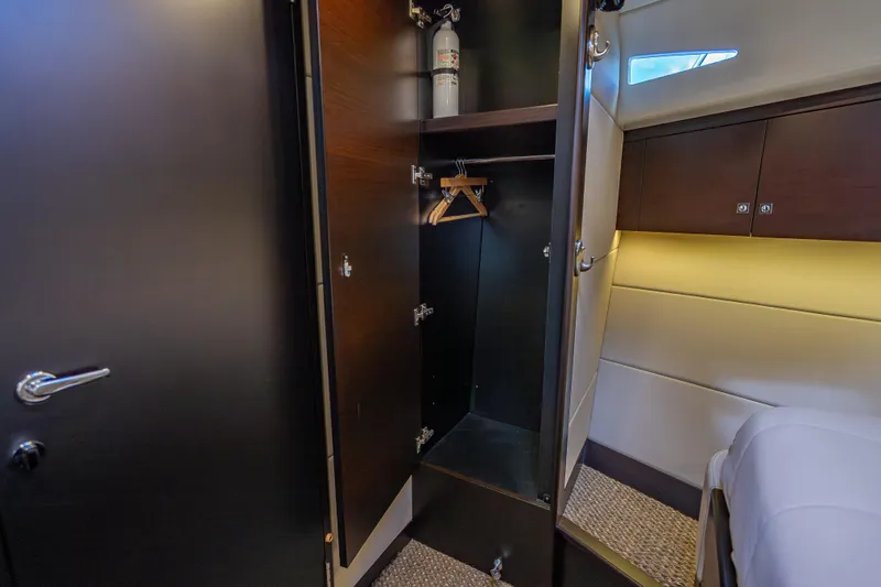 Priceless Yacht Photos Pics 2019 Palm Beach Motor Yachts GT50 interior closet with fire extinguisher and hangers.