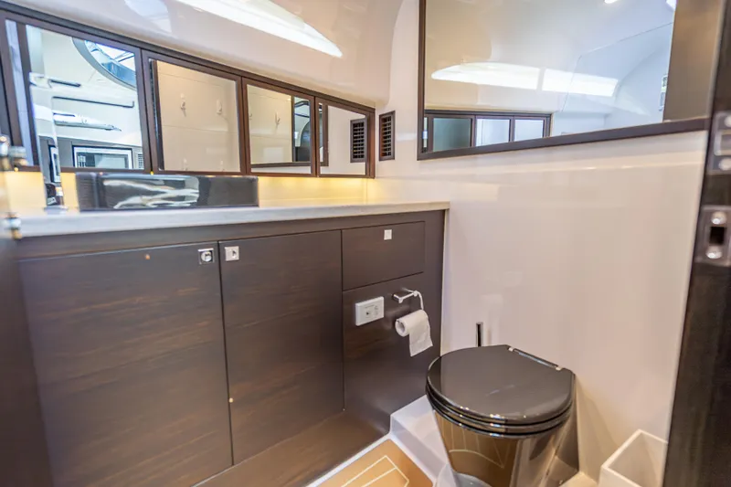 Priceless Yacht Photos Pics Luxurious bathroom in 2019 Palm Beach Motor Yachts GT50, featuring sleek cabinetry and modern fixtures.