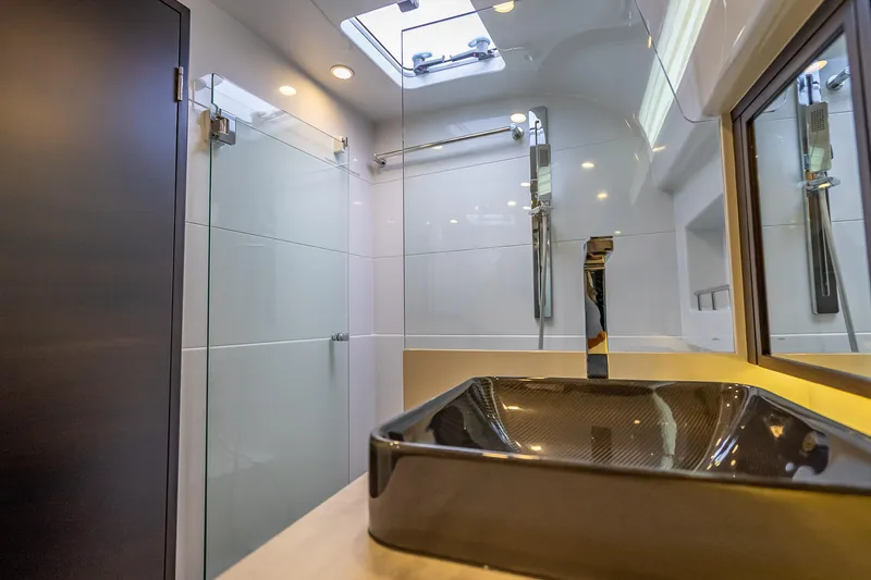 Priceless Yacht Photos Pics Luxurious bathroom in 2019 Palm Beach Motor Yachts GT50, featuring modern sink and shower.
