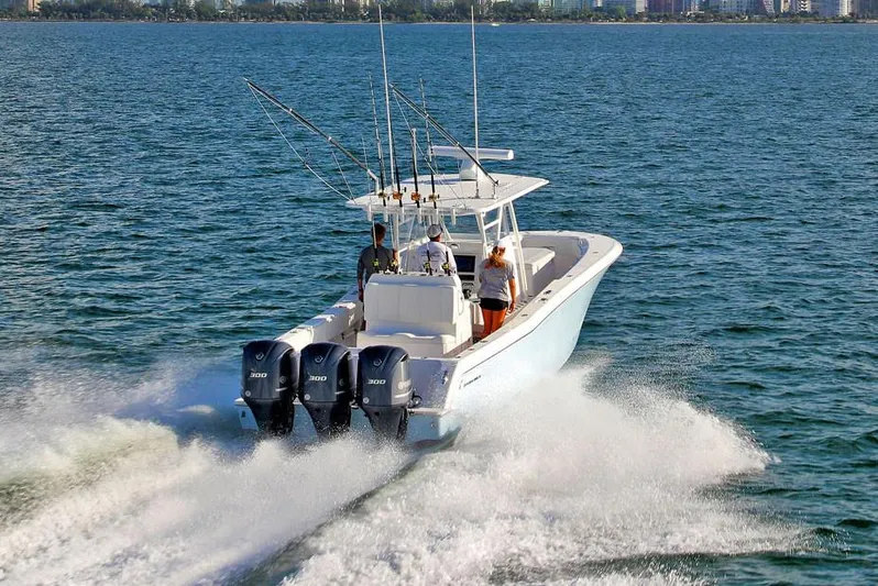  Yacht Photos Pics Manufacturer Provided Image: 2020 Invincible 36 Open Fisherman boat cruising on the water with triple outboard engines.