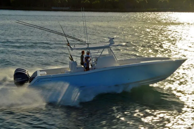  Yacht Photos Pics Manufacturer Provided Image: 2020 Invincible 36 Open Fisherman boat cruising on water at sunset.