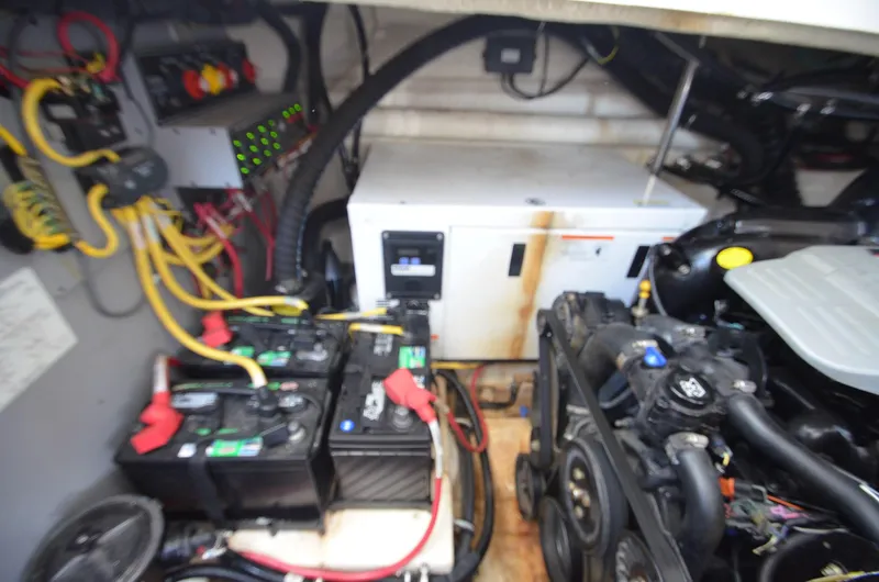 In The Raw Yacht Photos Pics Engine compartment of a 2013 Monterey 340 SY boat, featuring batteries and wiring.