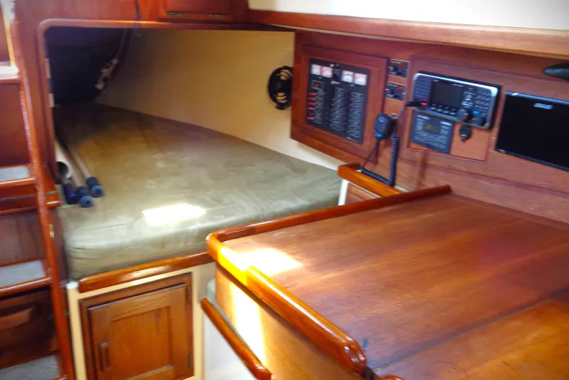 Adventure Yacht Photos Pics Interior of 1995 Pacific Seacraft 37 sailboat with navigation station and berth.