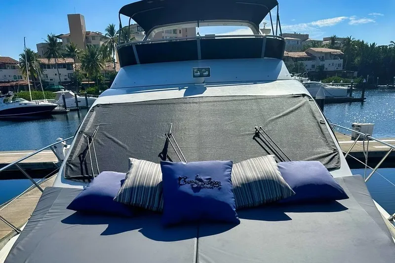 Chica Loca Yacht Photos Pics 2003 Azimut 55E yacht with cushions, docked in a sunny marina setting.