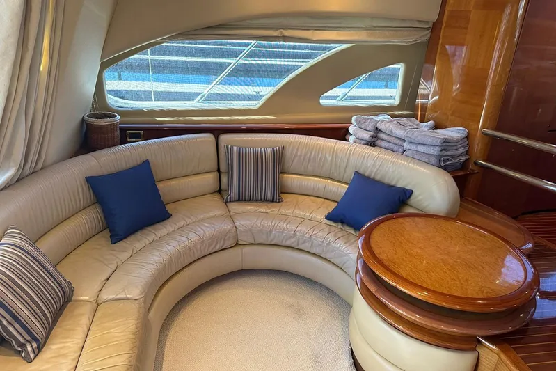 Chica Loca Yacht Photos Pics Luxurious interior of 2003 Azimut 55E yacht with curved leather seating and elegant decor.