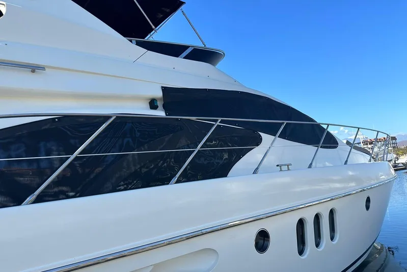 Chica Loca Yacht Photos Pics 2003 Azimut 55E yacht side view, sleek design, docked under clear blue sky.