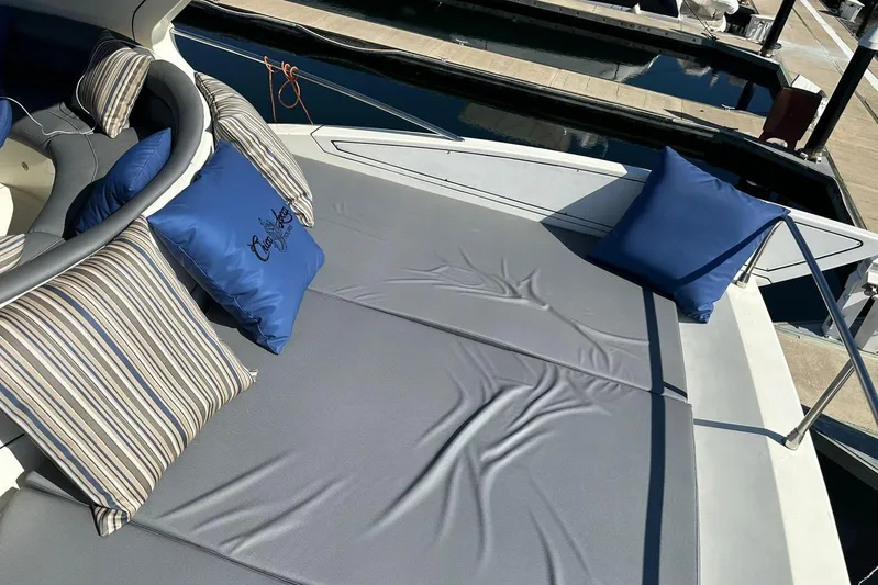 Chica Loca Yacht Photos Pics Luxurious 2003 Azimut 55E yacht deck with cushions and pillows at marina.