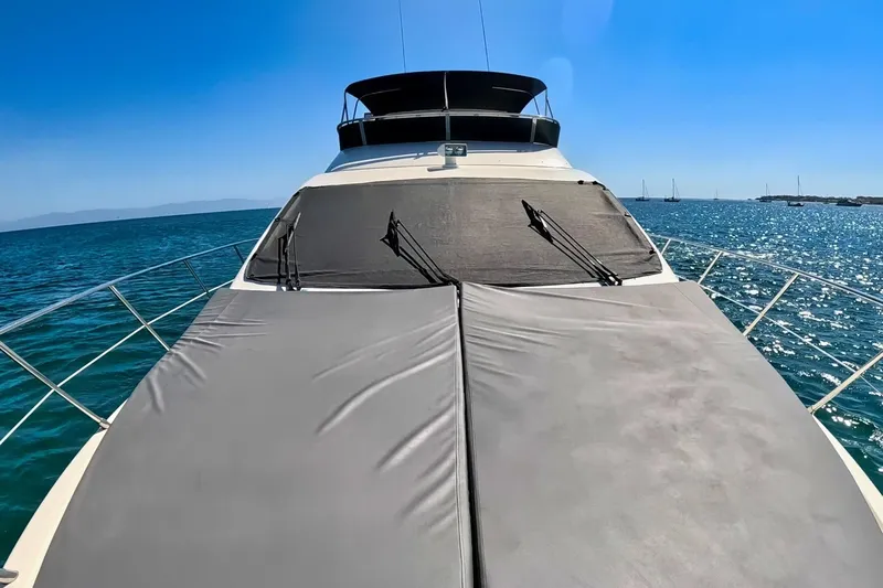 Chica Loca Yacht Photos Pics 2003 Azimut 55E yacht on open sea under clear blue sky.