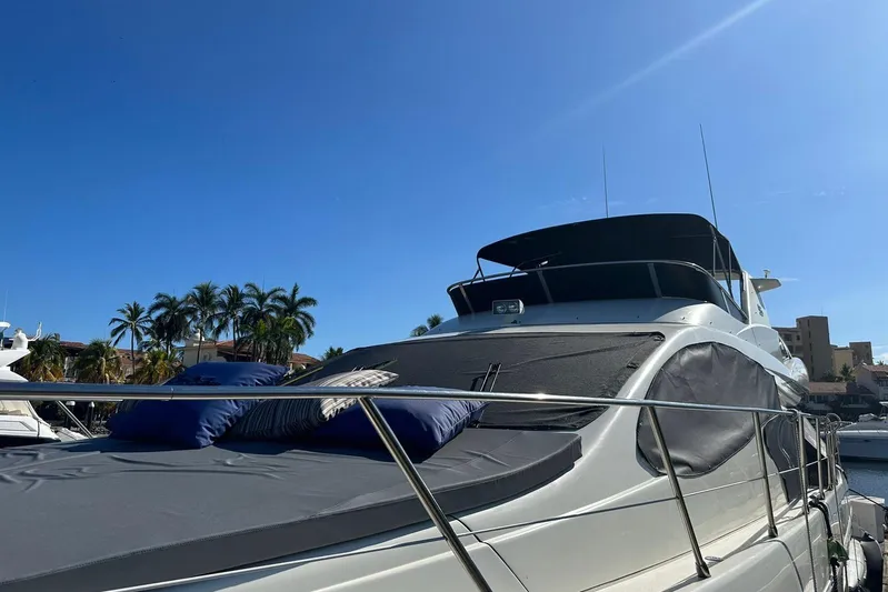 Chica Loca Yacht Photos Pics 2003 Azimut 55E yacht docked under clear blue sky with palm trees.